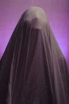 Spooky Ghost in a sheet on a purple background. Stock Photos