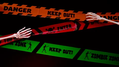 Spooky Halloween Decor: Skeleton Hand touching Warning Tapes Stock Footage 251491656
