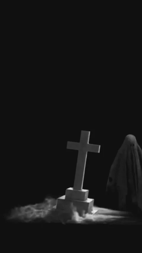 Spooky Halloween ghost beside a graveyard cross tombstone with eerie smoke. Stock Footage 318206753