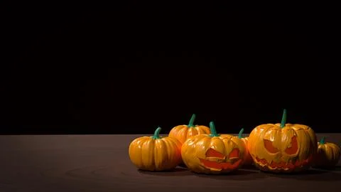 Spooky Halloween Jack O Lantern Pumpkins On Dark Table 3d render.. Illustrazione stock