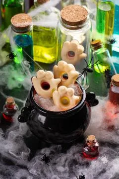 Spooky Halloween Witch Cauldron With Ghostly Hand Cookies And Potions Stock Photos