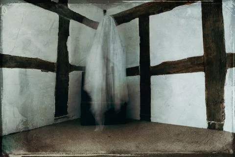 A spooky horror ghost, floating in the corner of the room. Stock Photos