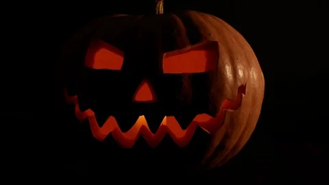 Spooky jack-o-lantern or carved pumpkin lantern burning in darkness. Stock Footage 116154563