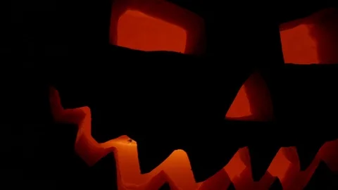 Spooky jack-o-lantern or carved pumpkin lantern burning in darkness. Stock Footage 116154615