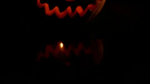 Spooky jack-o-lantern or carved pumpkin lantern burning in darkness. Stock Footage 116154635