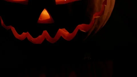 Spooky jack-o-lantern or carved pumpkin lantern burning in darkness. Stock Footage 116154731