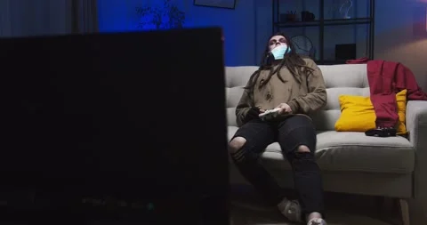 Spooky living dead with dreadlocks sitting on sofa at the costume Halloween Stock Footage 134948490