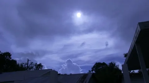 Spooky looking timelapse of clouds moving through sky wiyh bright moon visible Stock Footage 41476845
