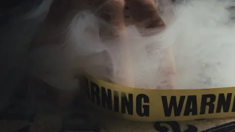 Spooky Pale Hand and Warning Tape in Smoke on Spirit Board Stock-Footage 346457066