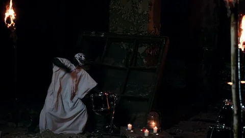 Spooky psycho in a mask plays drums with a long haired drummer Stock Footage 92177232