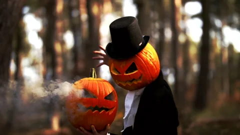 Spooky Pumpkin Headed Man Performing A Halloween Trick With Smoke In The Forest Stock Footage 141259037