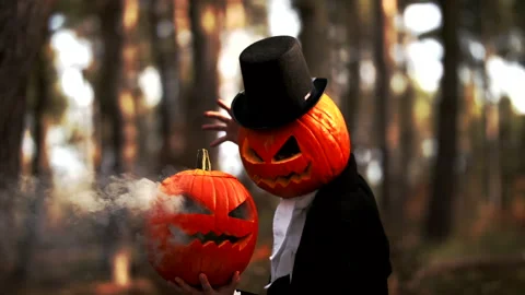 Spooky Pumpkin Headed Man Performing A Halloween Trick With Smoke In The Forest Stock Footage 141259384