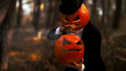 Spooky Pumpkin Headed Man Performing A Halloween Trick With Smoke In The Forest Stock Footage 141259484