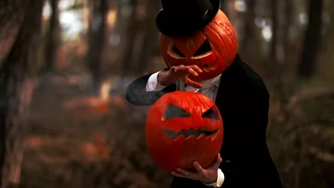 Spooky Pumpkin Headed Man Performing A Halloween Trick With Smoke In The Forest Stock Footage 141259741