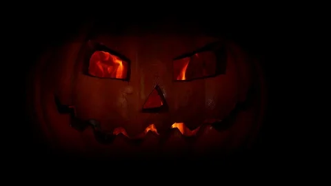 Spooky pumpkin jack-o-lantern face with fire in the eye of darkness.4k. Video stock 116889035