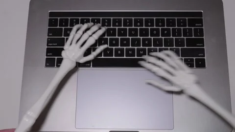 Spooky skeleton hands typing away during... | Stock Video | Pond5
