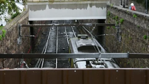 Spooky Train Passing Under the Bridge in Dun Laoghaire Stock Footage 141019479