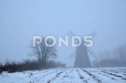 Spooky windmill a foggy day Stock Photos