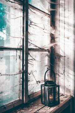 Spooky window with lantern and spider web. Stock Photos