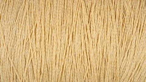 Spool of beige thread macro background Stock Photos