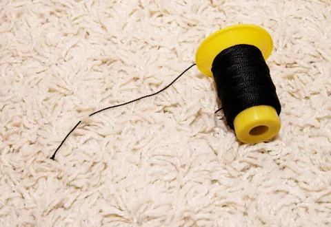Spool of black thread lies on a white background Stock Photos