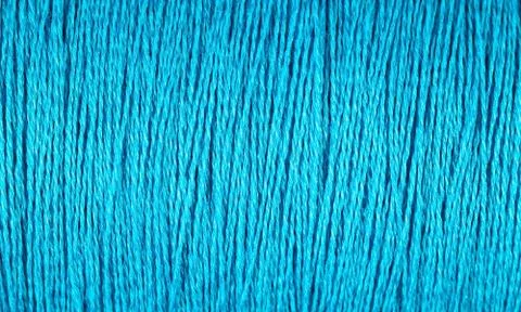 Spool of blue thread macro background Stock Photos