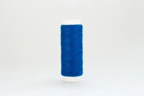 Spool of blue thread on a white background Stock Photos
