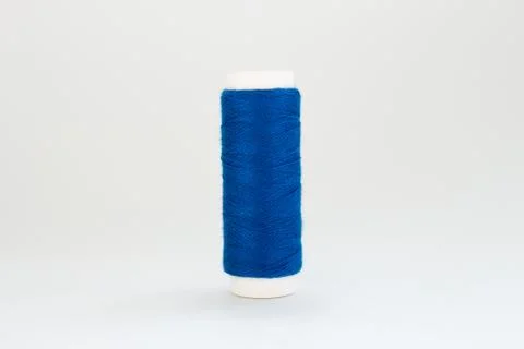 Spool of blue thread on a white background Stock Photos