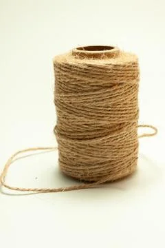 Spool of coarse thread on a white background Stock Photos