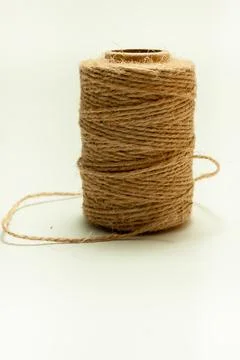 Spool of coarse thread on a white background Stock Photos