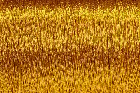 The spool of gold thread closeup Stock Photos