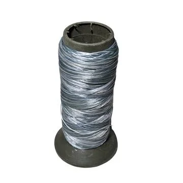 Spool of Gray Synthetic Thread on Dark Bobbin 스톡 사진