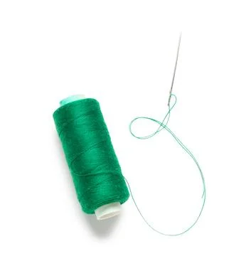 Spool of green thread with needle on white background Stock Photos
