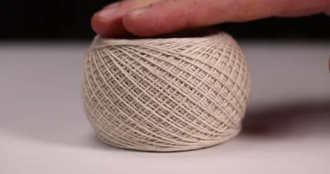 A spool of light thread for sewing, a skein of thread for knitting and sewing Stock Footage 277278540