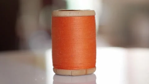 Spool of orange cotton thread for sewing close-up 動画素材 281590448