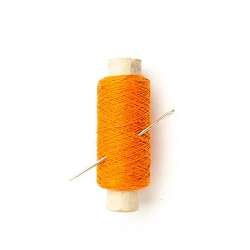 Spool of orange thread with needle isolated on white. Stock Photos