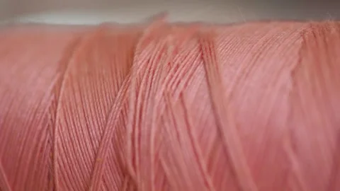 Spool of pink cotton thread for sewing macro 動画素材 281590428