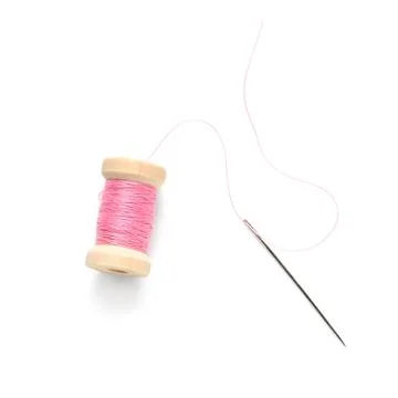 Spool of pink thread with needle on white background Stock Photos