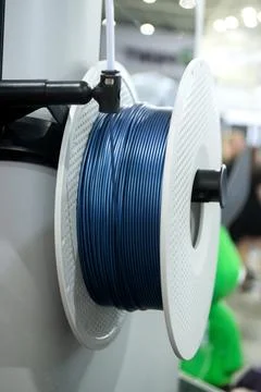 Spool plastic wire for 3D printing. Spool with blue plastic close-up. Component Stock Photos