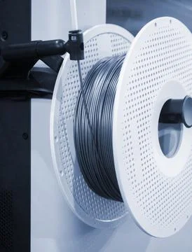 Spool plastic wire for 3D printing. Spool with blue plastic close-up. Component Stock Photos