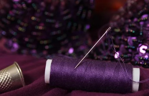 Spool of Purple Thread on Beaded Fabric Stock Photos