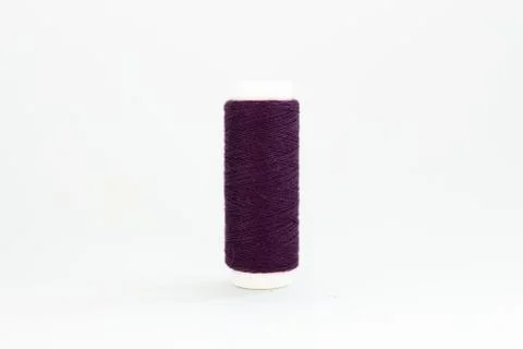 Spool of purple thread on a white background Stock-Fotos