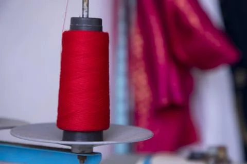 A Spool of red color swing thread with a Shallow depth of field Stock Photos