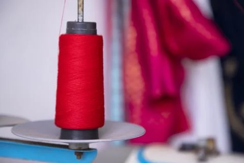A Spool of red color swing thread with a Shallow depth of field Stock Photos