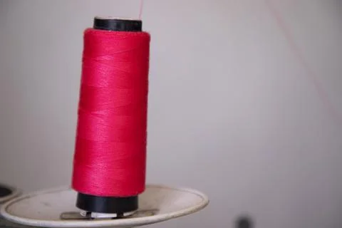 A Spool of red color swing thread with a Shallow depth of field Stock Photos