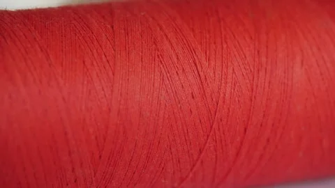 Spool of red cotton thread for sewing macro 動画素材 281590419