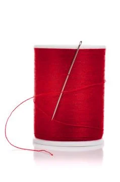 Spool of red thread and needle on white Stock Photos