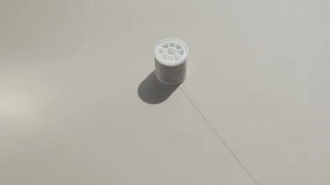 A spool of sewing thread in a beautiful pastel color enchantingly moves Stock Footage 204024820