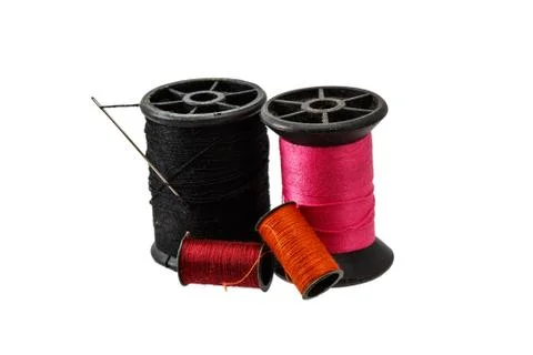 Spool thread and needle isolated on white background . Stock Photos