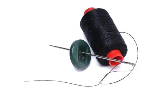 Spool of thread and needle Stock Photos